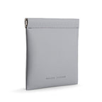 Light gray Mark Ryden coin pouch with smooth texture, metal clip, and secure design for effortless valuables carry.