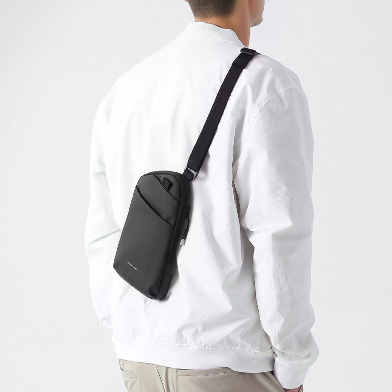 Modern professional wearing black ProCarry sling bag - MarkRyden Global business accessory