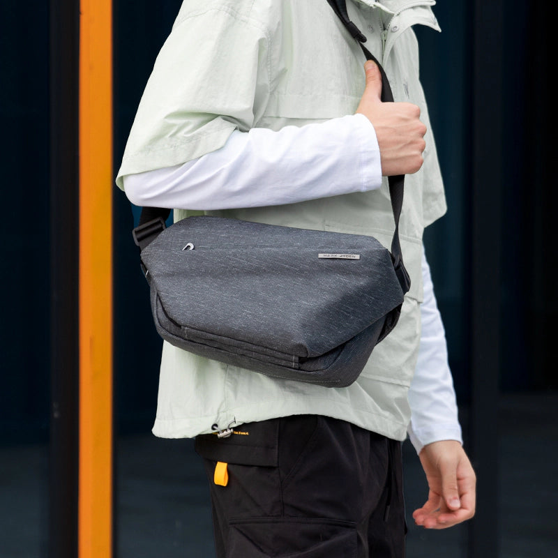 Mark Ryden Global: Gray large capacity city commuter messenger bag on person in light jacket