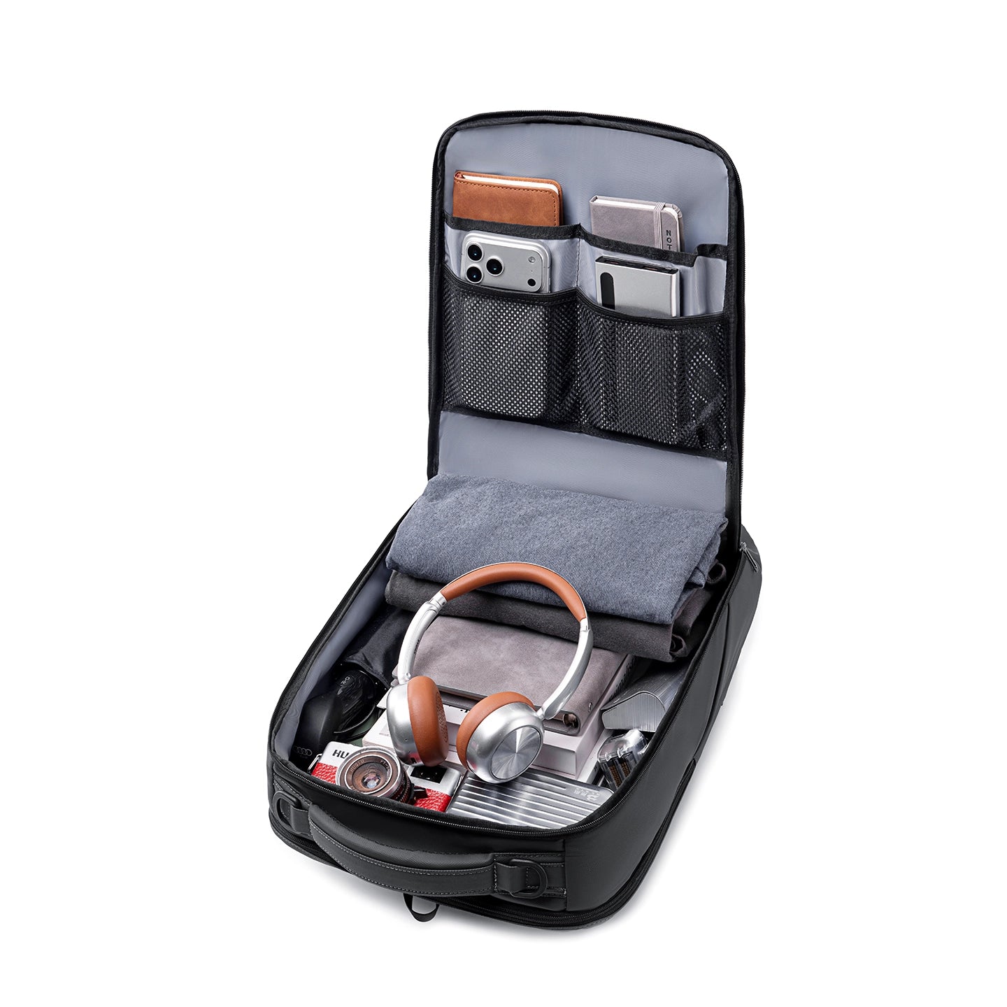 Compacto Pro MarkRyden backpack: black exterior, gray interior, open to display organized compartments with headphones, folded clothes, camera, phones, and notebooks—futuristic design, large capacity for daily use.
