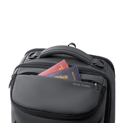 Mark Ryden black futuristic daily backpack with front pocket holding passports