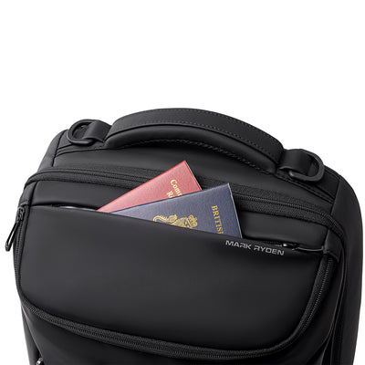 Mark Ryden black backpack with red/blue passports in front pocket - daily travel bag
