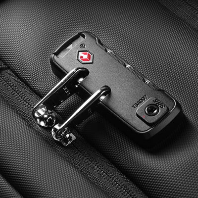 Close-up of black TSA-approved lock with red logo attached to textured strap of MARK RYDEN Expandos Max anti-theft compression backpack.