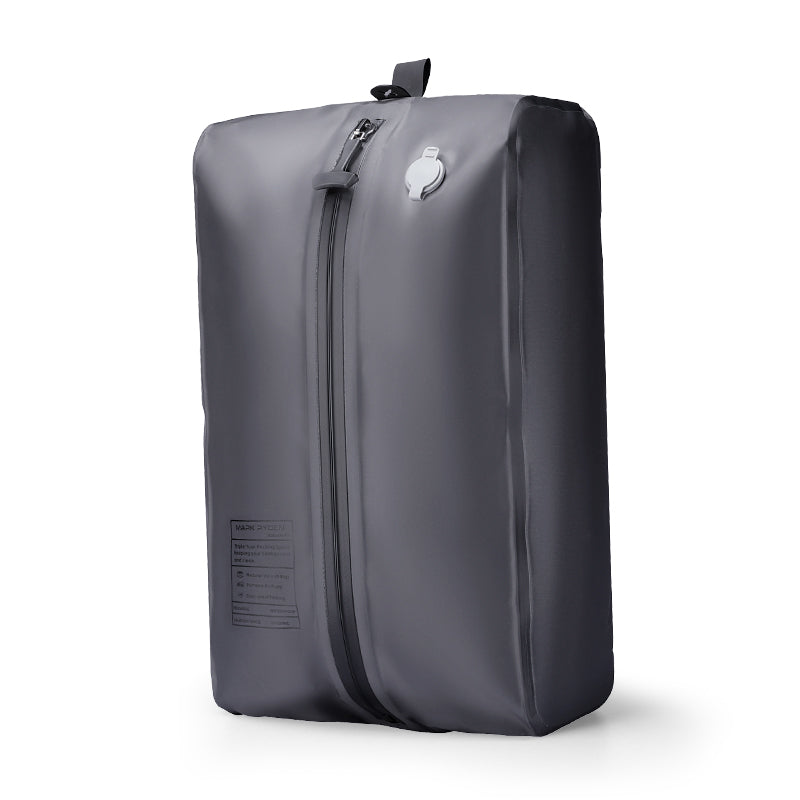 Gray Mark Ryden VacSpace sealed compression bag with zipper and valve, designed to create more space for travel essentials.