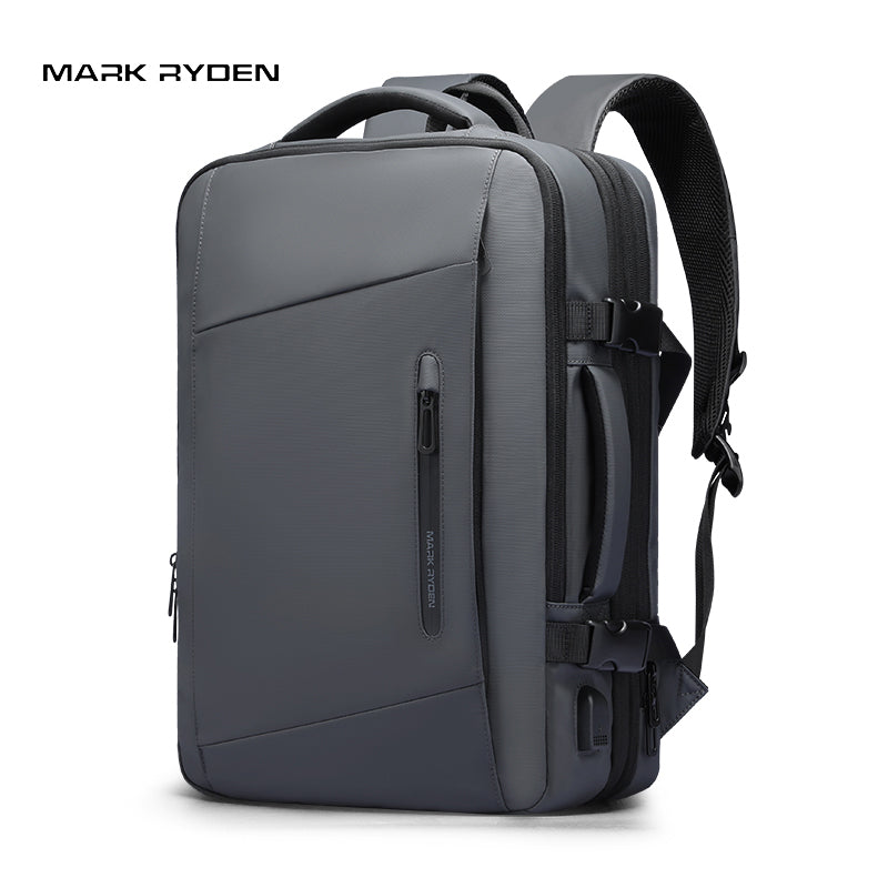 Mark Ryden Expandos gray expandable laptop backpack with front zipper, side compartments, padded straps, and USB port for all-day travel.