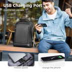 Black durable waterproof high-capacity travel backpack with USB port, shown charging a smartphone, highlighting multi-functional design for modern travelers.