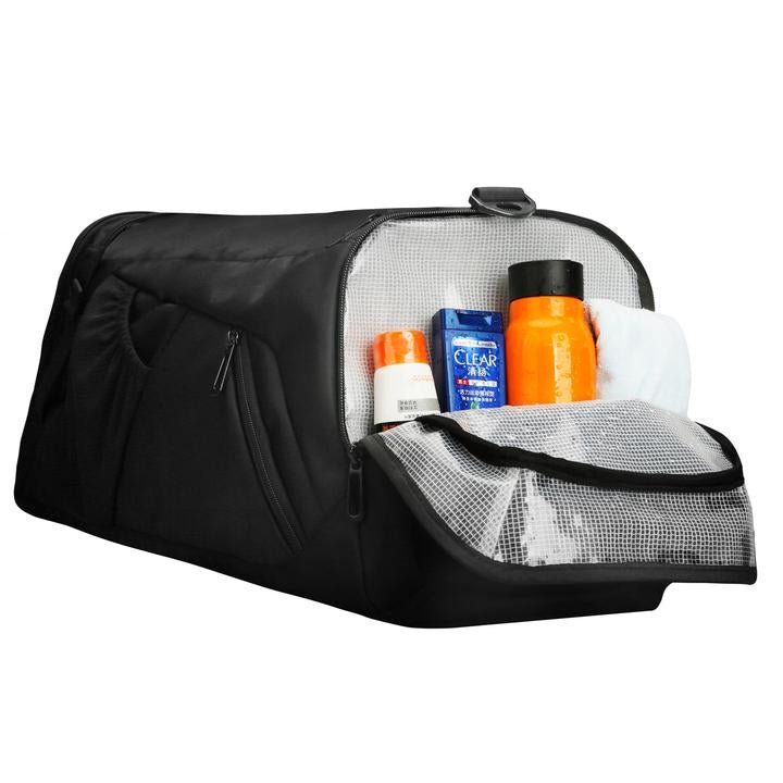 Black spacious durable polyester travel bag with open mesh pocket holding toiletries including orange bottle, blue box, and white item.